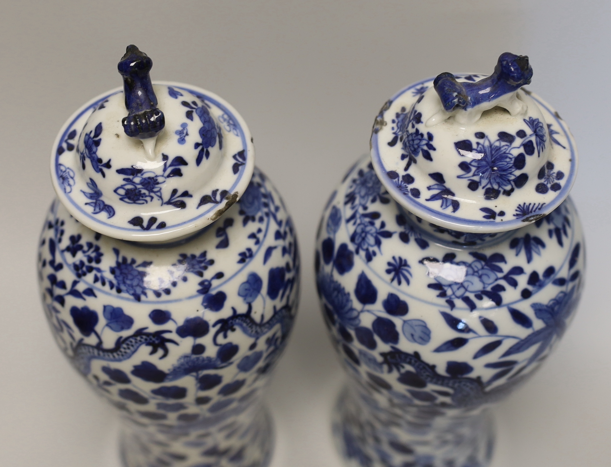 A pair of Chinese blue and white 'dragon’ vases and covers, Late 19th century, 29cm high